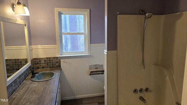 full bath featuring a wainscoted wall and vanity