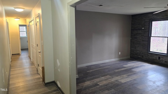 interior space featuring baseboards and wood finished floors