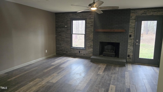 unfurnished living room featuring a wealth of natural light, ceiling fan, and wood finished floors