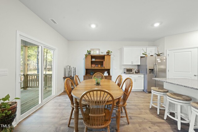 dining room with a toaster, recessed lighting, visible vents, and light wood finished floors