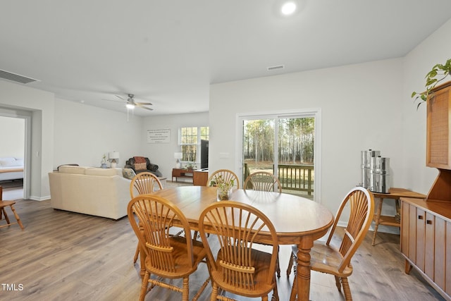 dining area with a ceiling fan, visible vents, and light wood-type flooring