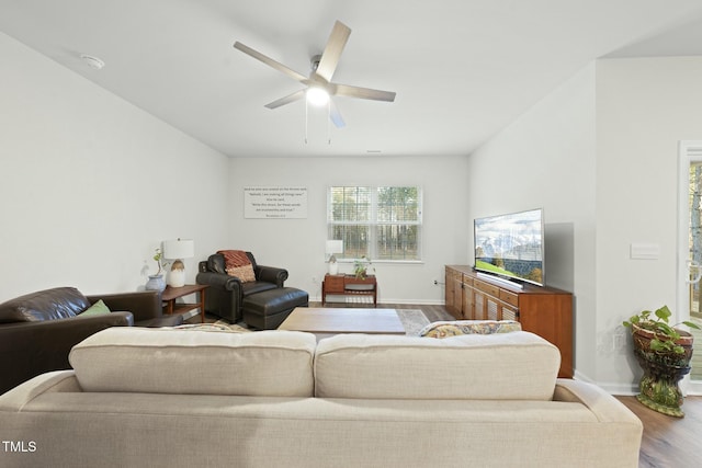 living room with baseboards, ceiling fan, and wood finished floors