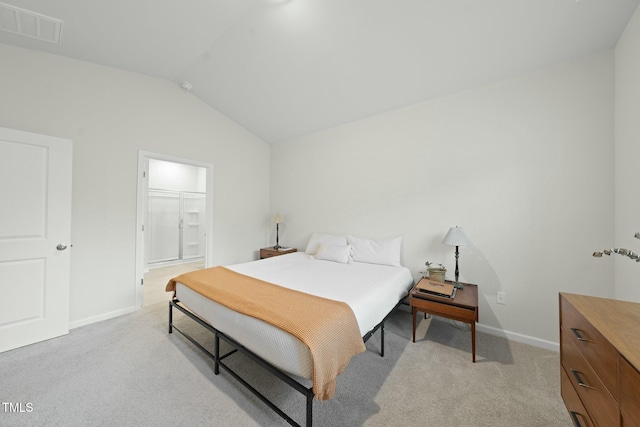 bedroom featuring visible vents, baseboards, light colored carpet, and vaulted ceiling