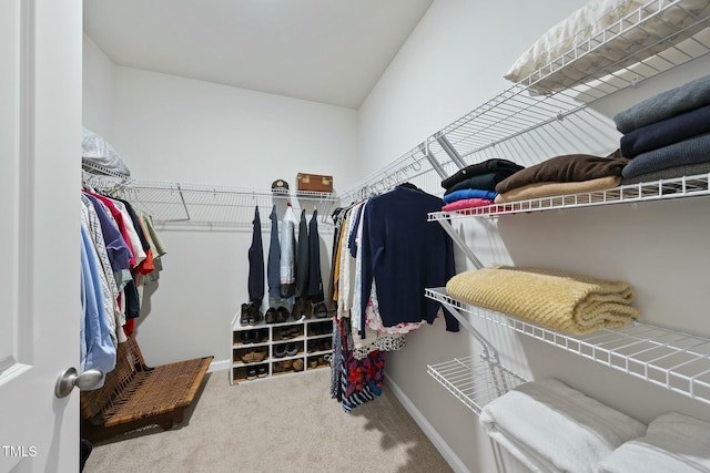 spacious closet with carpet and vaulted ceiling