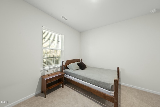 bedroom featuring light colored carpet, visible vents, and baseboards