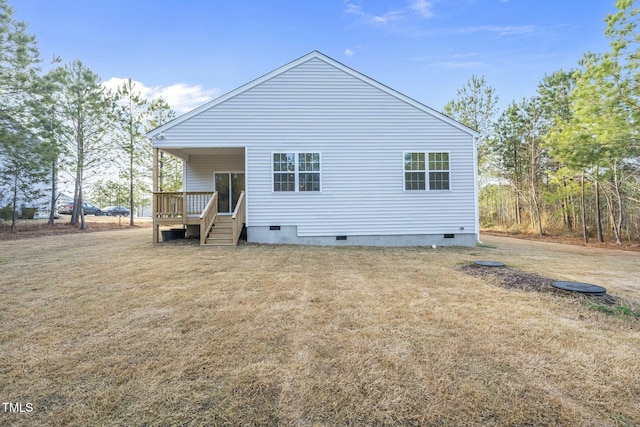 rear view of house with a deck, a yard, and crawl space