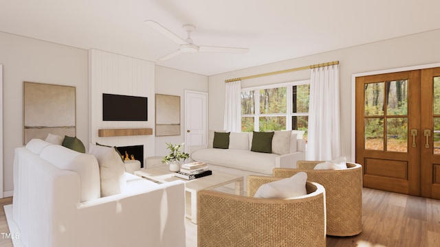 living room with a ceiling fan, french doors, light wood-type flooring, and a large fireplace