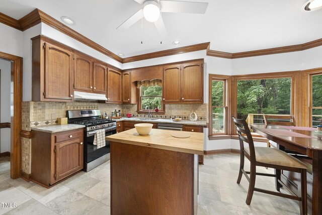 2705 Vestry Way, Raleigh, NC 27613 - kitchen with appliances with stainless steel finishes, under cabinet range hood, wood counters, ornamental molding, and tasteful backsplash