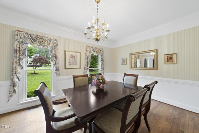 2705 Vestry Way, Raleigh, NC 27613 - dining area with crown molding, a chandelier, wood finished floors, and wallpapered walls