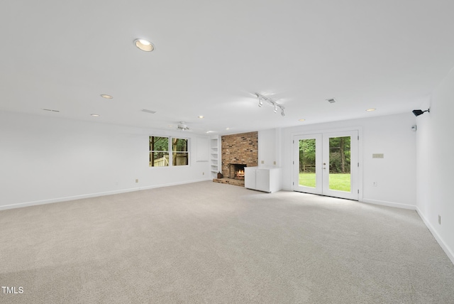 2705 Vestry Way, Raleigh, NC 27613 - unfurnished living room featuring a fireplace, healthy amount of natural light, baseboards, recessed lighting, and light carpet