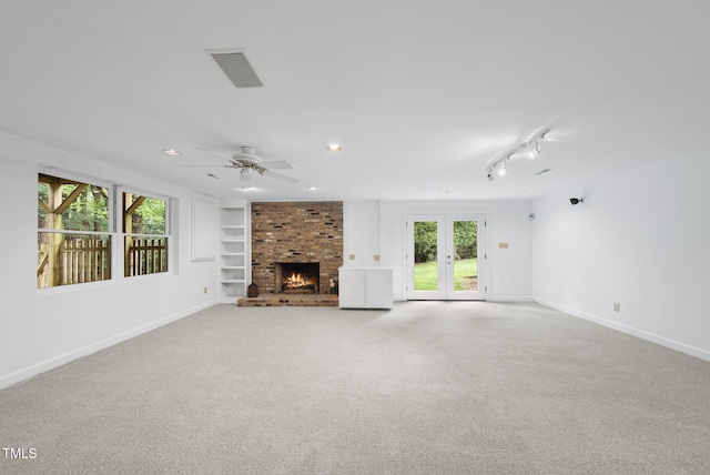 2705 Vestry Way, Raleigh, NC 27613 - unfurnished living room featuring a ceiling fan, carpet flooring, baseboards, a fireplace, and built in shelves