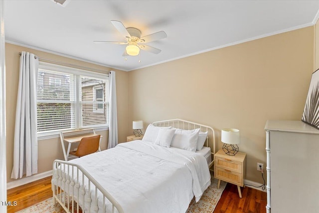 bedroom with ornamental molding, a ceiling fan, baseboards, and wood finished floors