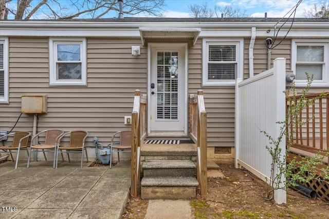 entrance to property featuring a patio