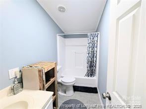 full bath featuring vanity, toilet, and shower / tub combo with curtain