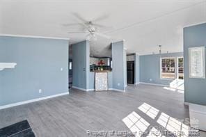 unfurnished living room featuring baseboards and ceiling fan