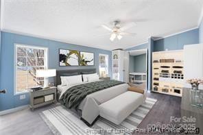 bedroom featuring baseboards, wood finished floors, a ceiling fan, and crown molding