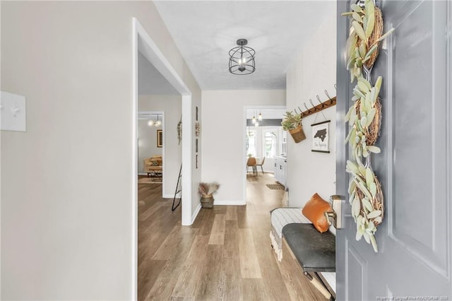 entryway featuring baseboards and light wood finished floors