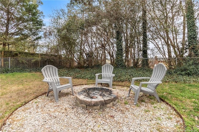 view of yard featuring a fire pit and a fenced backyard