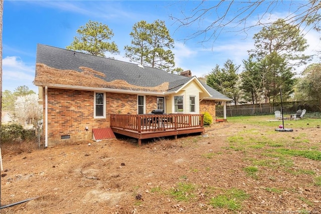 back of house featuring a deck, fence, a yard, crawl space, and brick siding