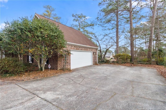 garage featuring concrete driveway