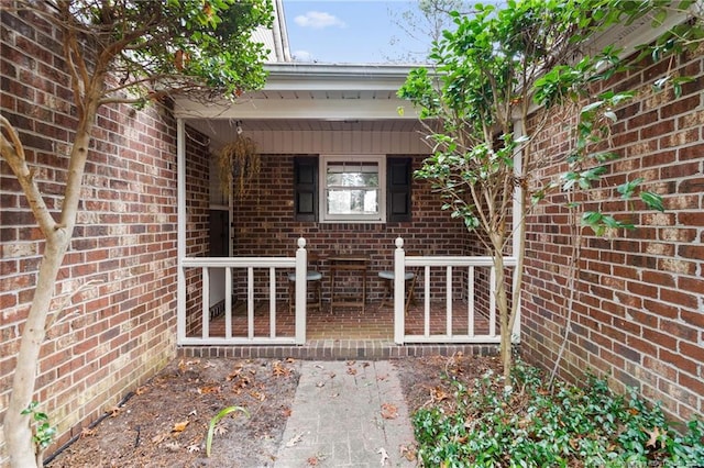 view of exterior entry with brick siding