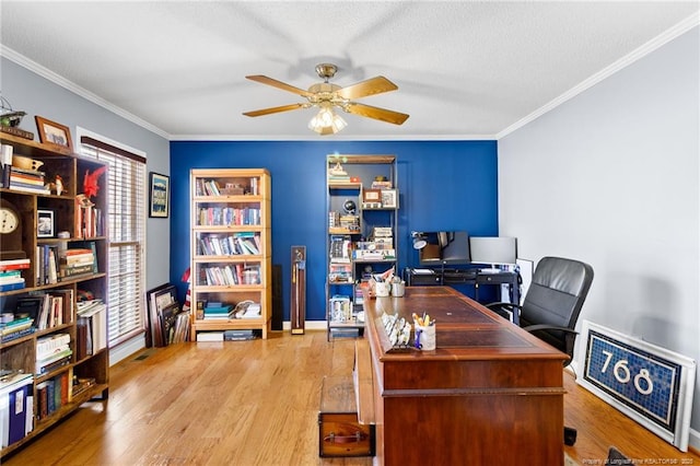 office area featuring light wood finished floors, a textured ceiling, a ceiling fan, and ornamental molding