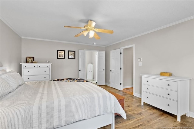 bedroom with a ceiling fan, baseboards, light wood-style floors, and crown molding