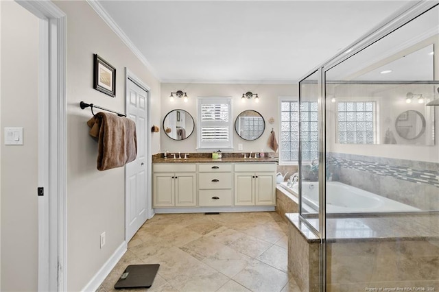 bathroom featuring crown molding, a garden tub, double vanity, and a sink