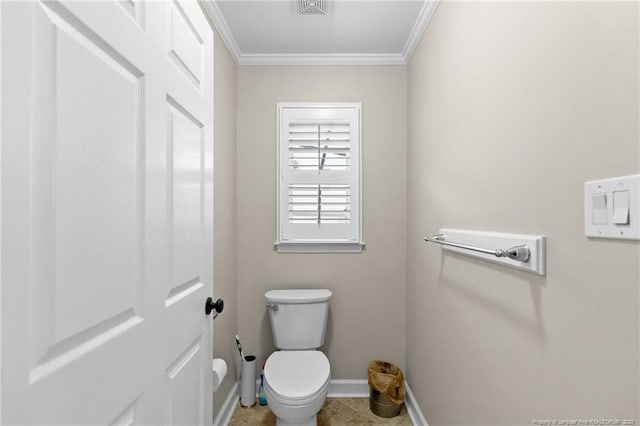 bathroom with crown molding, toilet, and baseboards