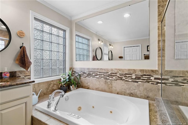 bathroom featuring vanity, a jetted tub, and crown molding