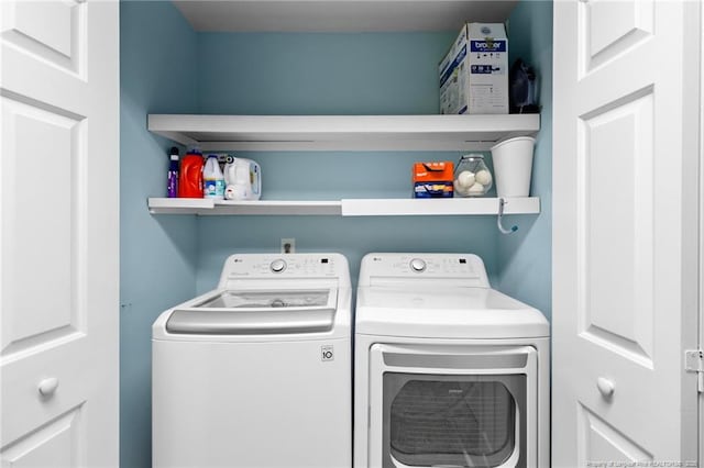 clothes washing area with washer and dryer and laundry area