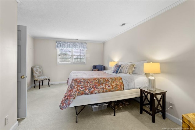 bedroom with visible vents, crown molding, baseboards, and carpet floors