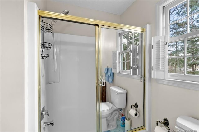 bathroom featuring toilet, plenty of natural light, and a textured ceiling