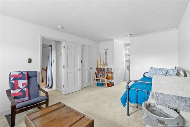 carpeted bedroom featuring visible vents, a textured ceiling, crown molding, and baseboards