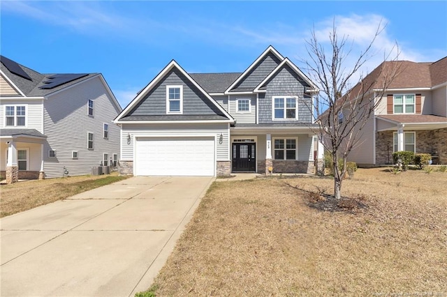 craftsman inspired home featuring driveway, a porch, a garage, stone siding, and central air condition unit