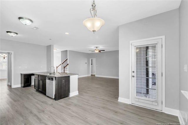 kitchen with a ceiling fan, baseboards, pendant lighting, dishwasher, and light wood-type flooring