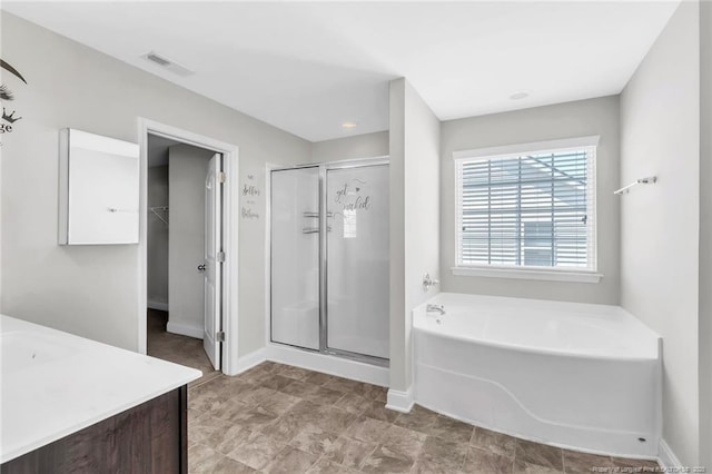 full bath with vanity, a garden tub, visible vents, and a stall shower