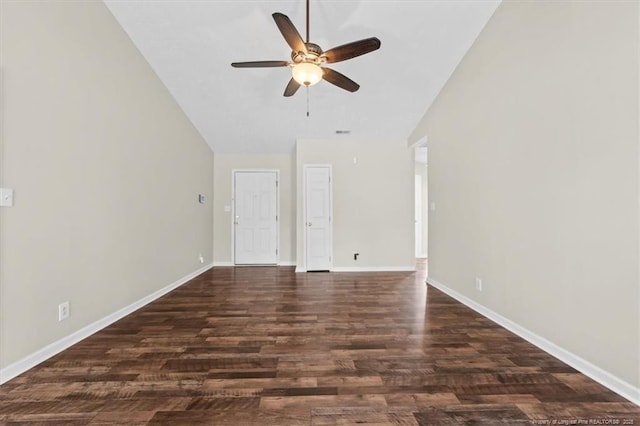 unfurnished room featuring baseboards, lofted ceiling, dark wood-style flooring, and a ceiling fan