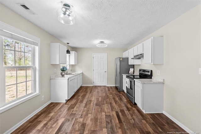 kitchen with visible vents, baseboards, dark wood-style floors, stainless steel appliances, and a sink