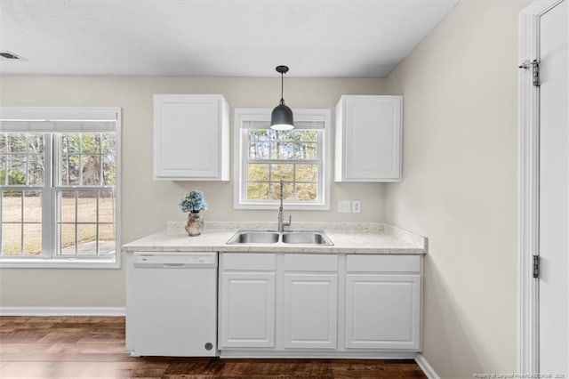 kitchen featuring white cabinetry, white dishwasher, and a sink