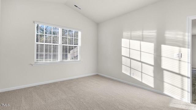 unfurnished room featuring vaulted ceiling, carpet flooring, visible vents, and baseboards