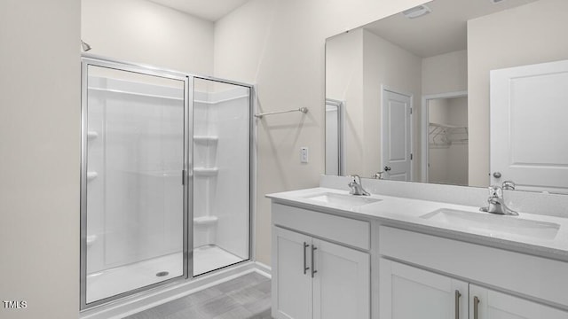 full bathroom featuring a shower stall, double vanity, visible vents, and a sink