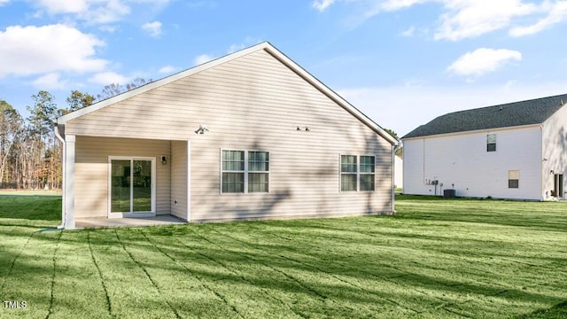 back of house featuring central air condition unit, a patio, and a yard