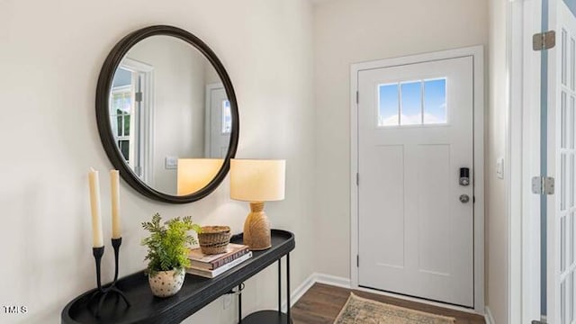 entryway featuring baseboards and dark wood-style flooring