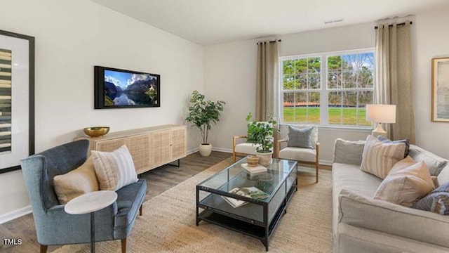 living room featuring wood finished floors and baseboards