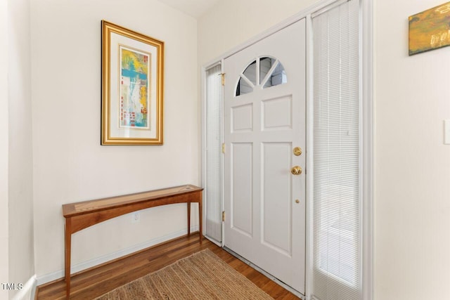 foyer featuring wood finished floors and baseboards