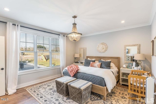 bedroom with wood finished floors, recessed lighting, an inviting chandelier, crown molding, and baseboards