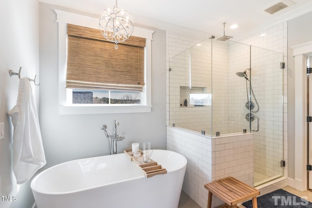 full bath with a chandelier, visible vents, a shower stall, and a freestanding bath