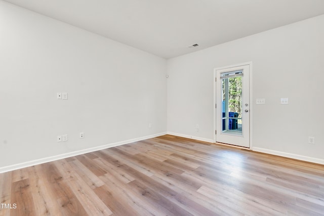 unfurnished room with visible vents, baseboards, and light wood-style flooring