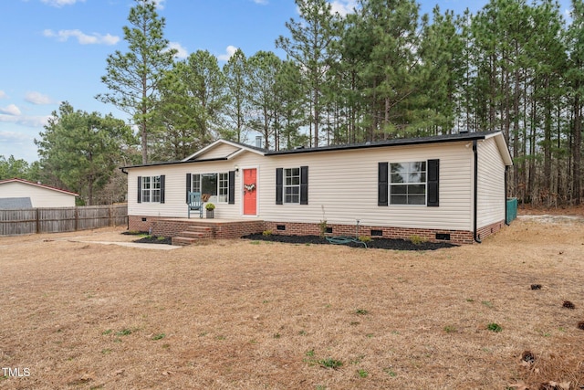 manufactured / mobile home featuring crawl space and fence